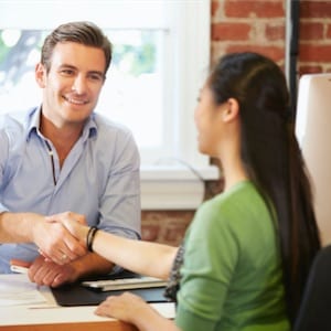 Man and Woman shaking hands in office