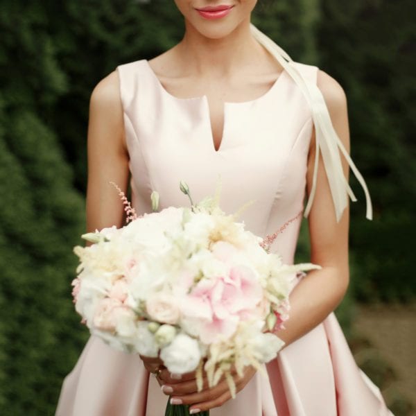 Women in wedding dress holding a bouquet of flowers
